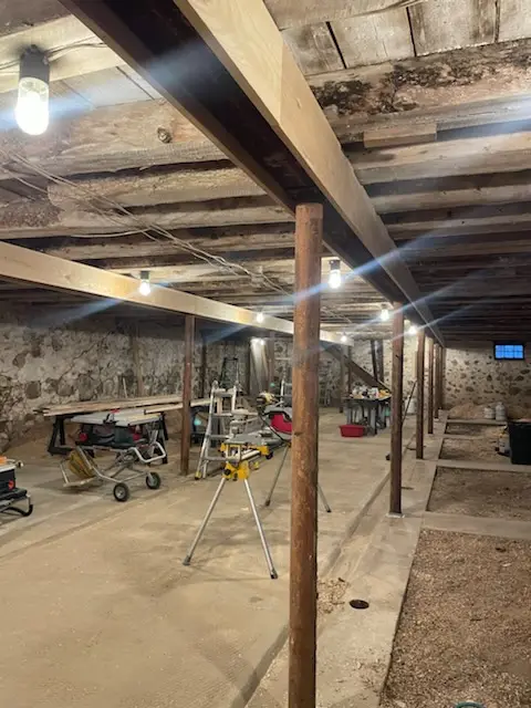 Stone-foundation barn lower level with new posts and beams