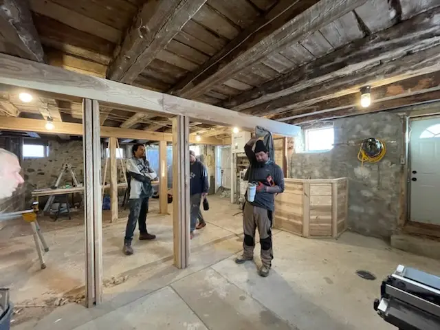 The crew framing stalls under the original beams