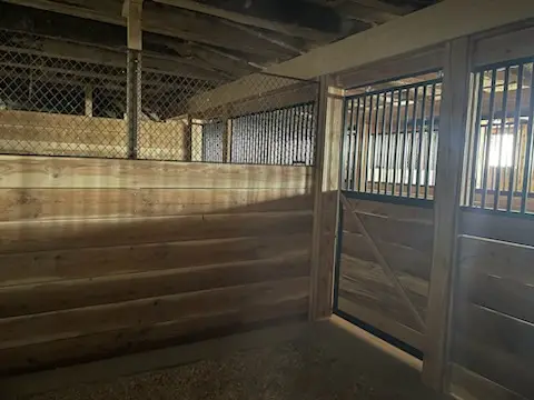 Finished stall with mesh grille and cedar planks