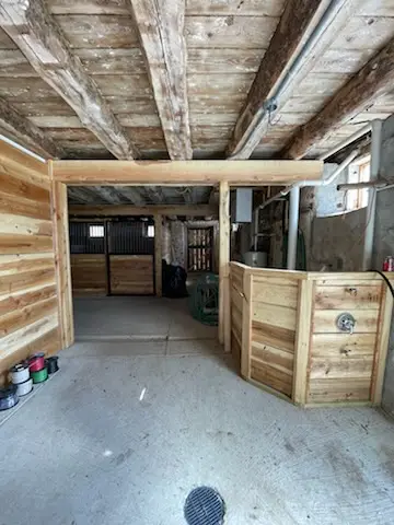 Aisle past the finished stalls and utility corner