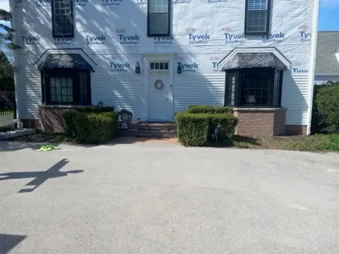 Both bays under construction across the front of the house