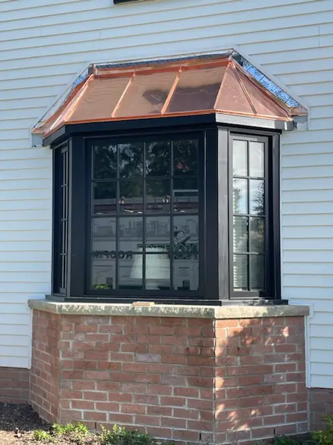 Standing-seam copper roof installed on a bay window