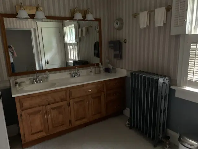 Before: double oak vanity and cast-iron radiator