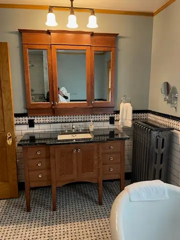 Antique oak triple medicine cabinet over a custom vanity