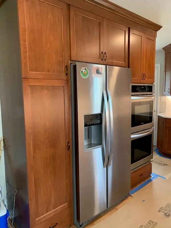 Pantry wall with built-in fridge and double ovens