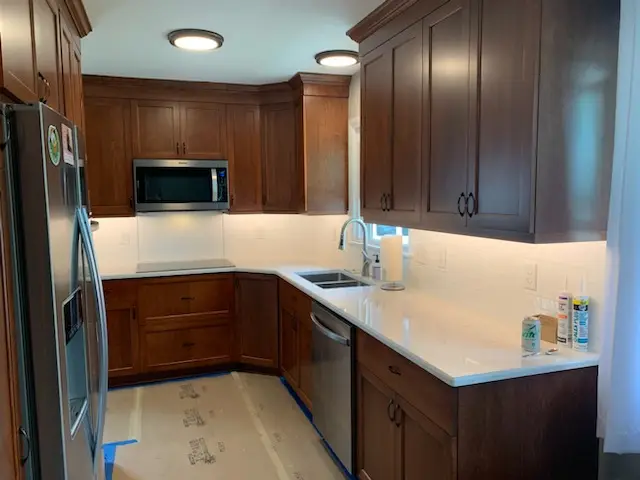 Sink run with under-cabinet lighting and new counters