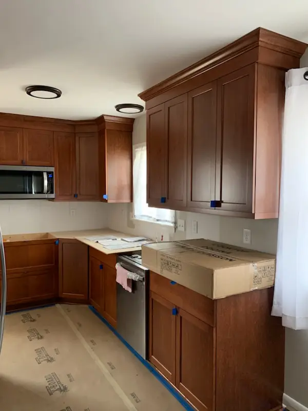 Cabinet installation in progress with crown detail