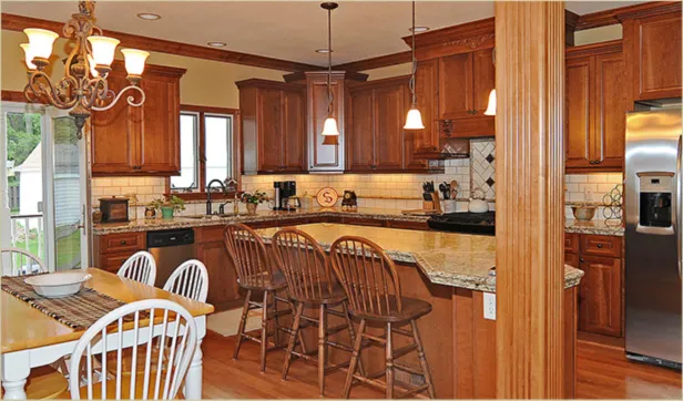 Kitchen remodel by Olde World Restoration with custom cherry cabinets, granite counters and a subway tile backsplash