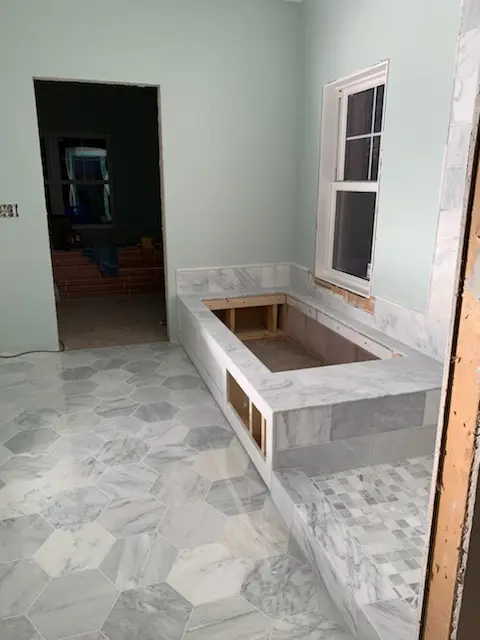 Marble tub surround and hex floor going in