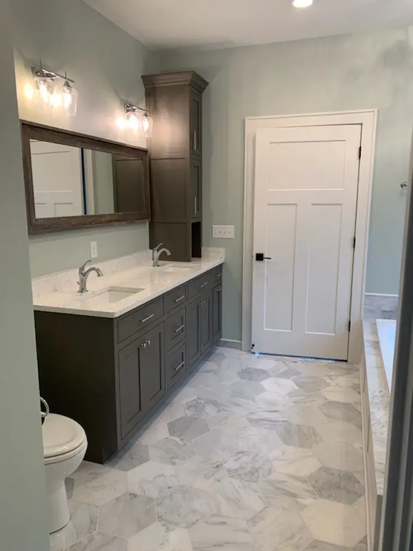 Finished double vanity, mirror, and hex marble floor