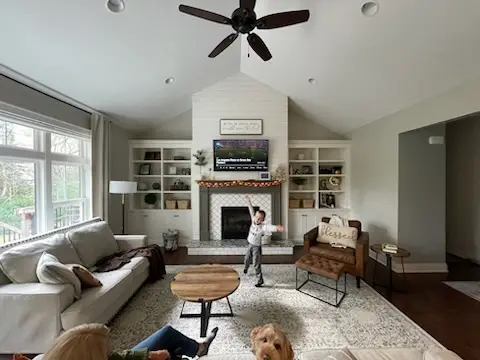 Vaulted great room with shiplap fireplace wall and built-ins