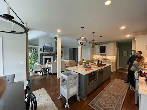 View across the island to the great room and fireplace