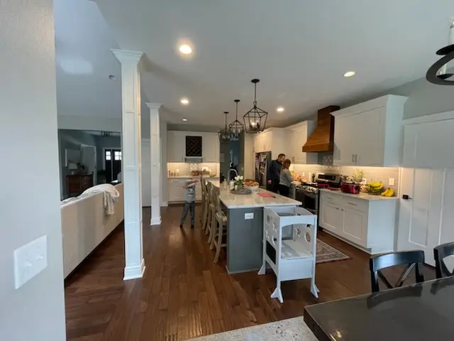 Kitchen seen through the columned opening from the living side