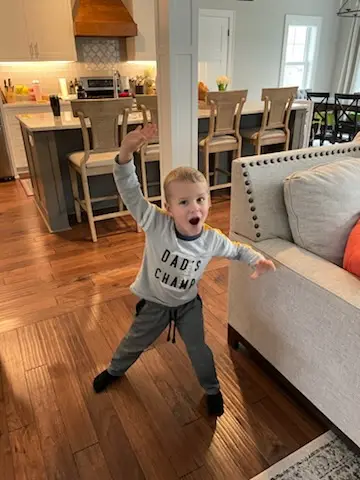 A very happy customer in front of the finished kitchen