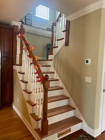 Custom staircase with turned spindles and stained rail